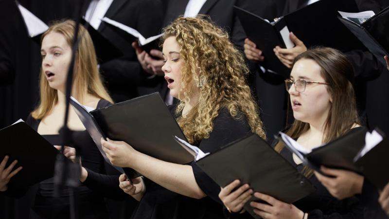 Female music students singing in choir